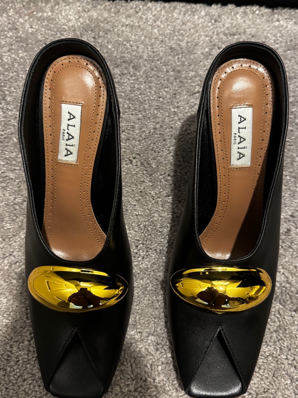 ALAIA Black Leather Mules with Gold Accent